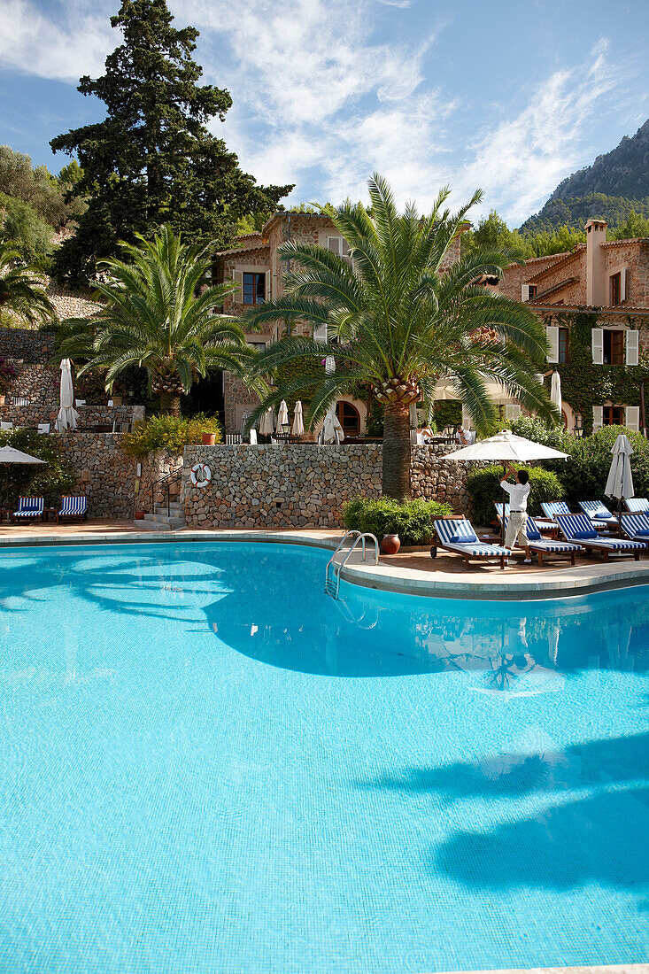 Deckchairs near a hotel swimming pool, Deia, Majorca, Spain