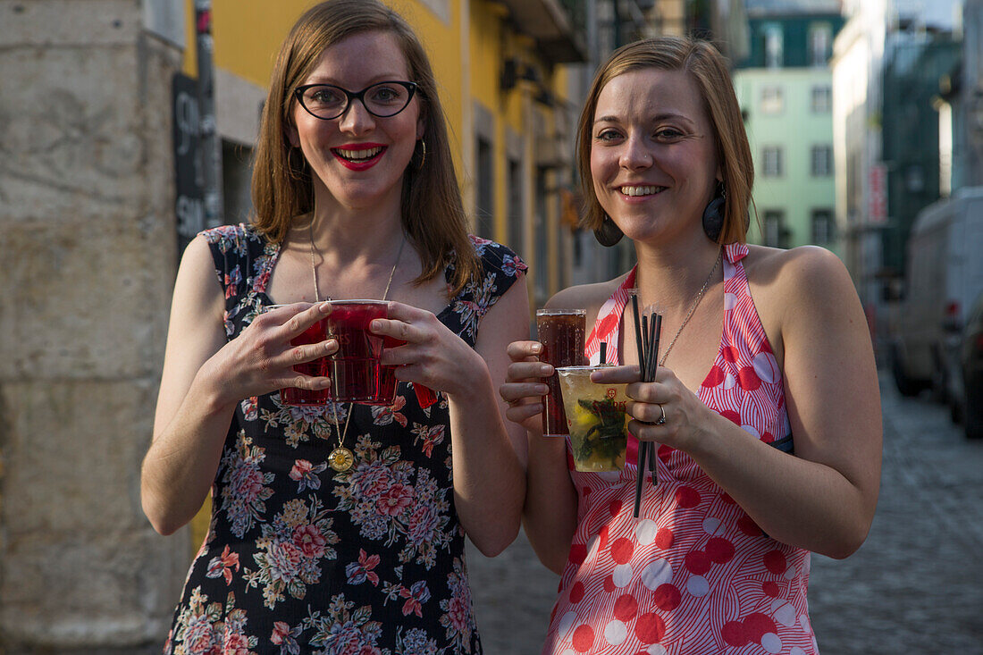 Two hip young women with cocktails in the Bairro Alto district, Lisbon, Lisboa, Portugal