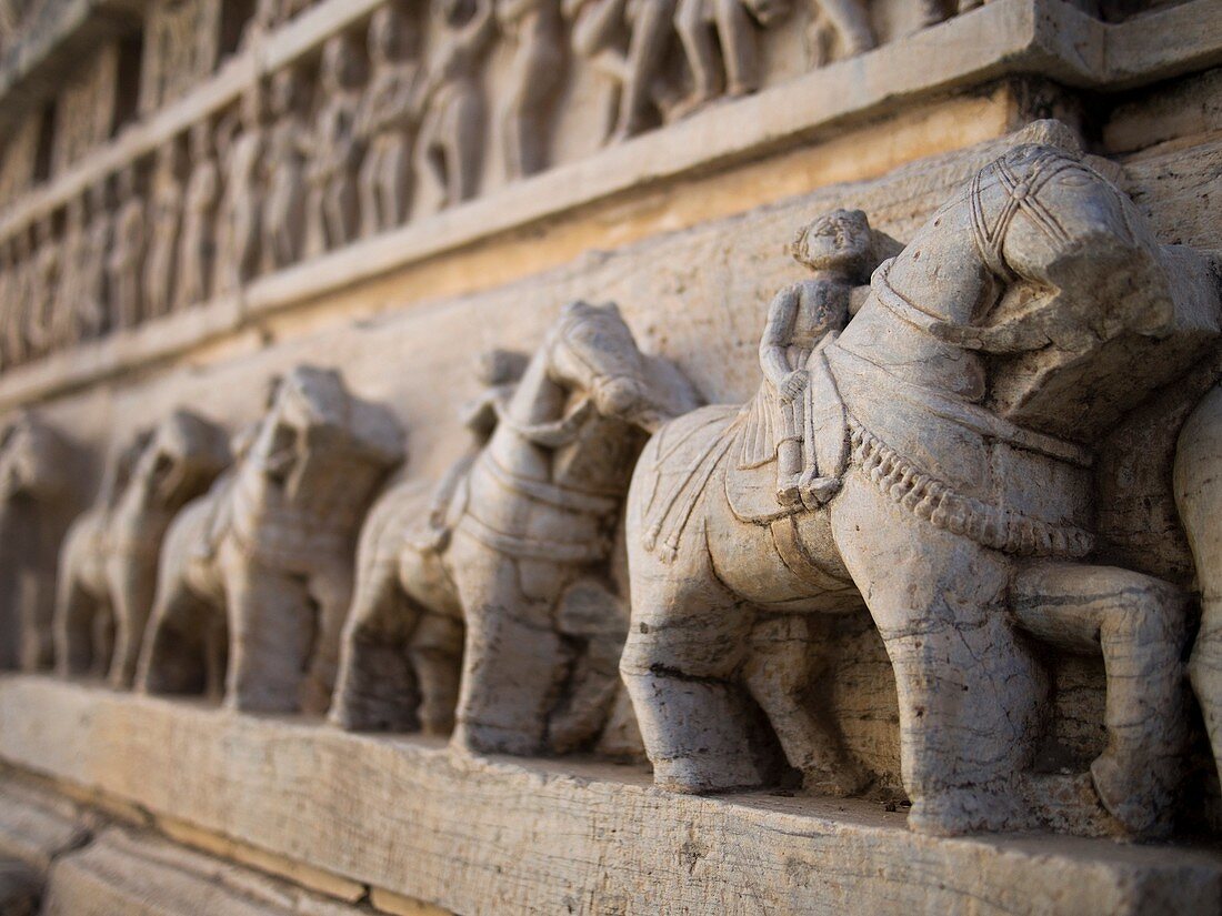 Statues of horseback riding warriors on exterior wall of a temple in Udaipur, Rajasthan, India