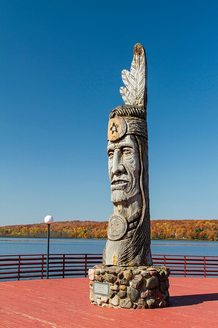 Wood craving of Indian totem pole at lakeside in Wakefield, Michigan, USA