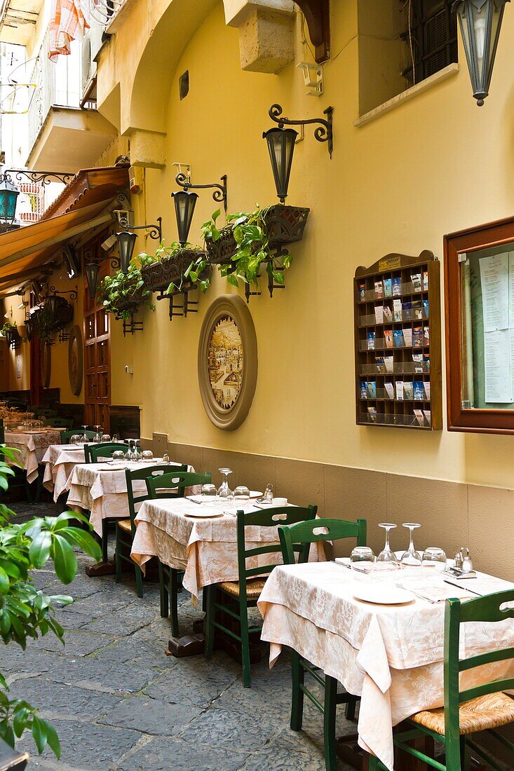 Tables and chairs at an outdoor restaurant in Sorrento, Campania, Italy