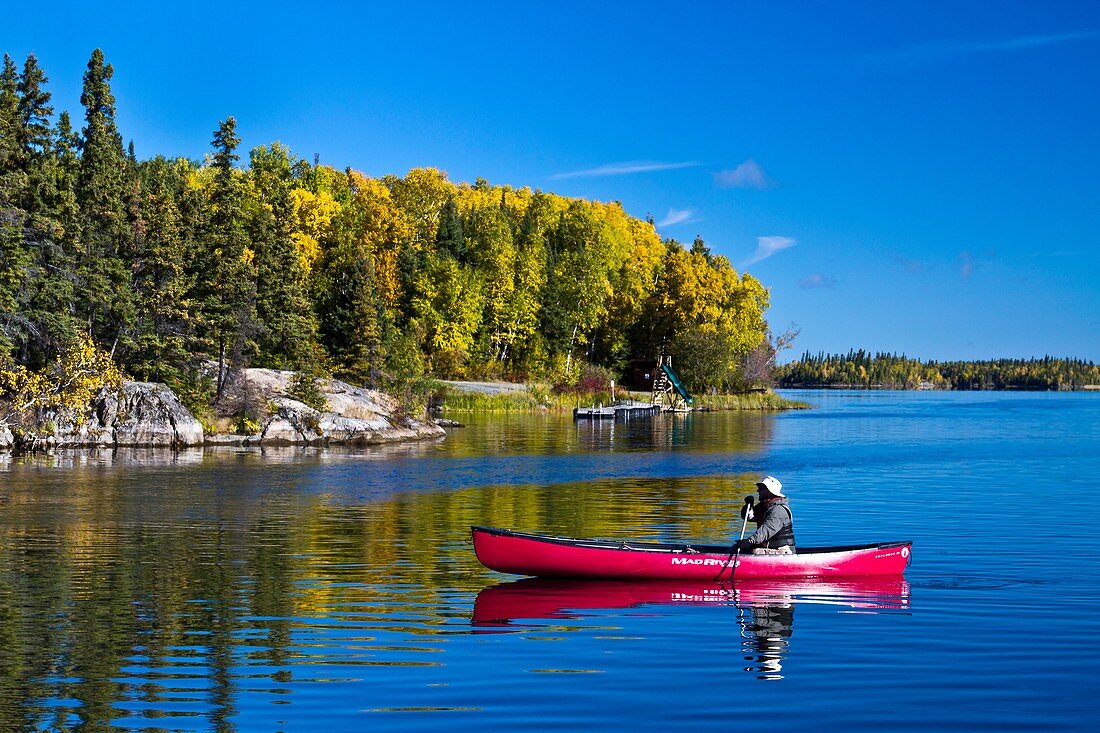 A northern Manitoba landscape of fall foliage color and reflections in a small lake at Baker Narrows near Flin Flon, Manitoba, Canada