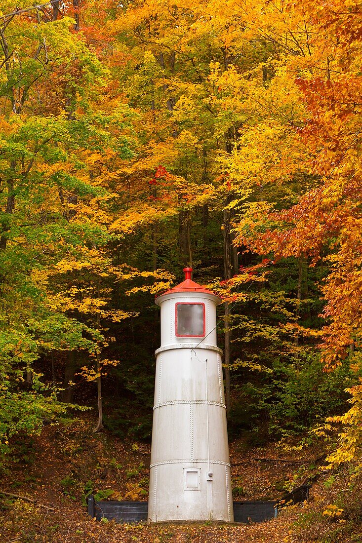 A hillside lighthouse beacon with fall foliage color in Munising, Michigan, USA