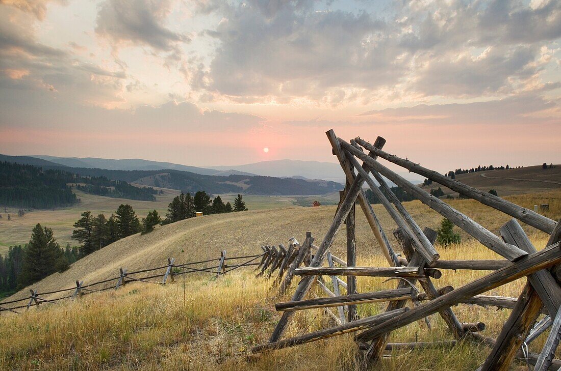 Classic log fence in ranch lands of Granite County Montana at sunset