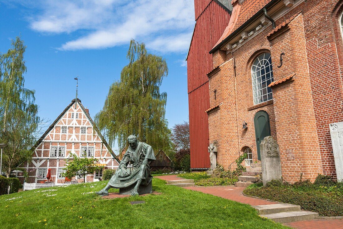 Statue of Monk Henry in front of St. Martini et Nicolai church in Steinkirchen, Lower Saxony, Germany, Europe