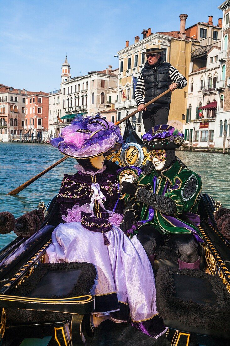A masked couple in a gondola at the carnival in Venice, Italy, Europe