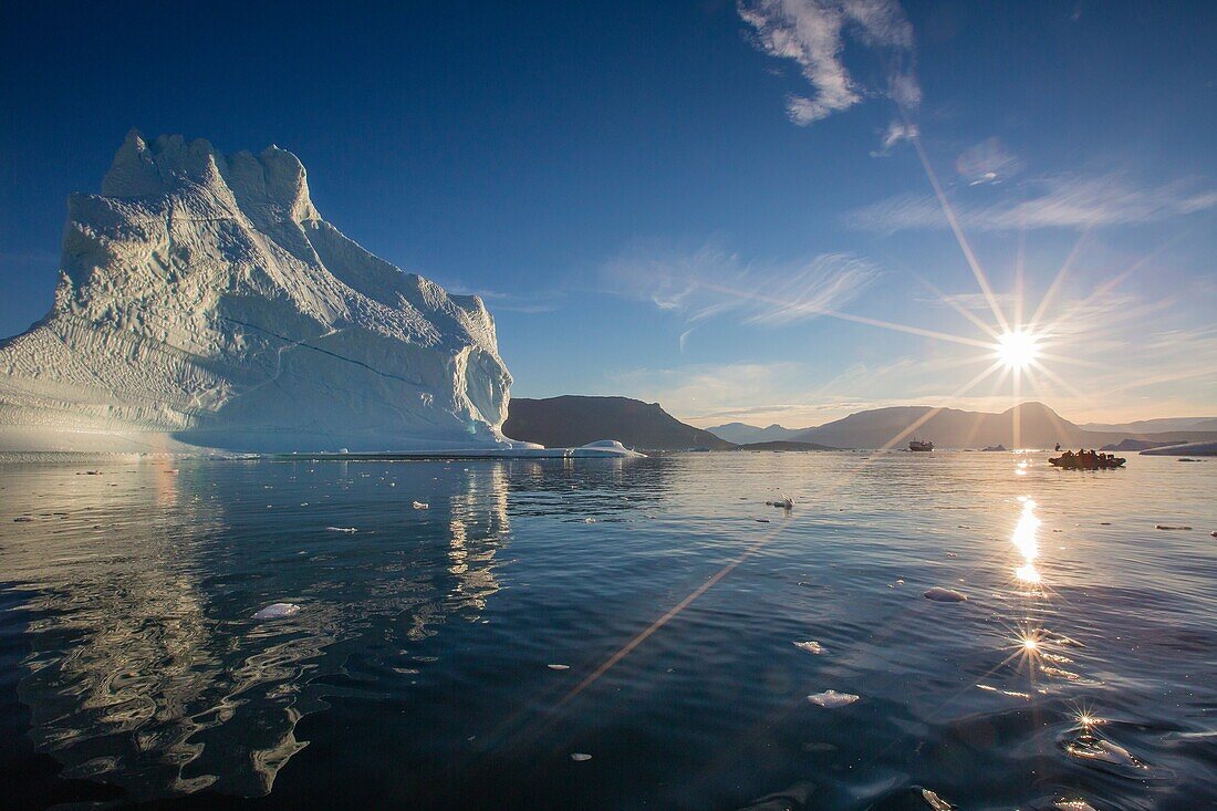 Zodiacs from the Lindblad Expeditions ship National Geographic Explorer amongst grounded icebergs near Rode O Red Island, Scoresbysund, Northeast Greenland