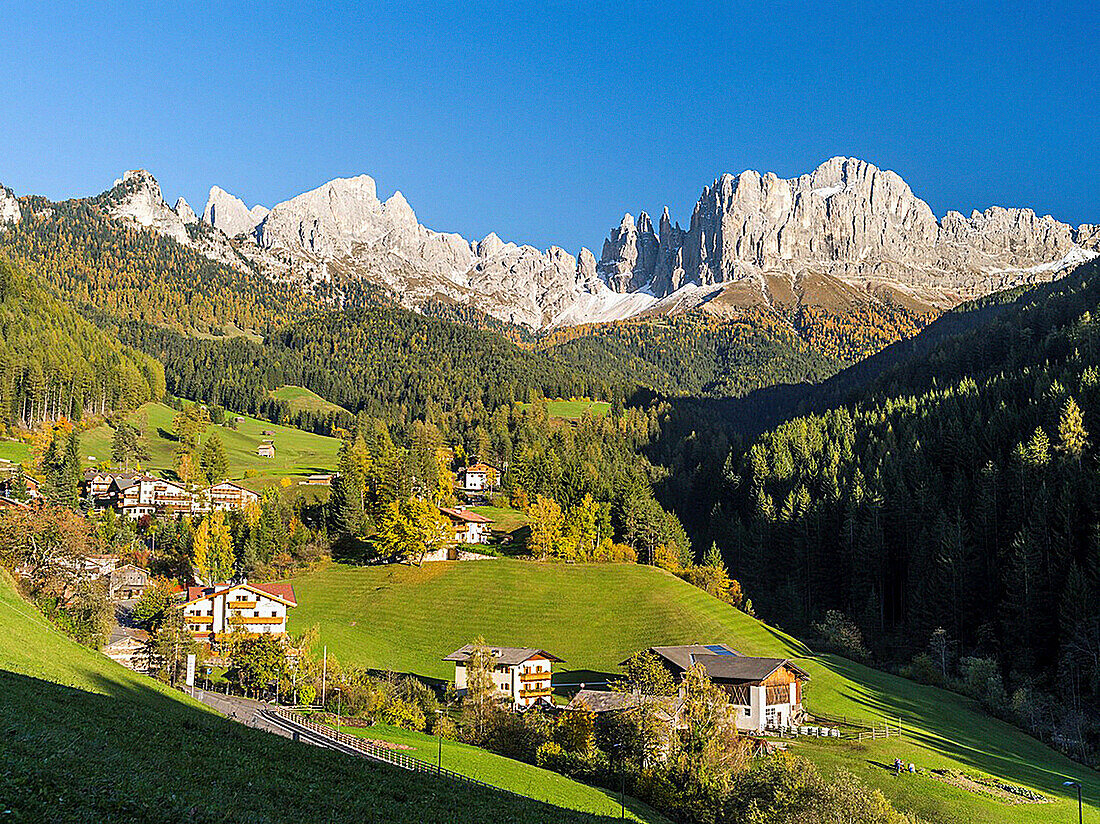 Rosengarten also called Catinaccio mountain range in the Dolomites of South Tyrol Alto Adige during autumn  The village Saint Zyprian or San Cipriano in the valley of Tiers  The Rosengarten is part of the UNESCO world heritage site Dolomites  Europe, Cent