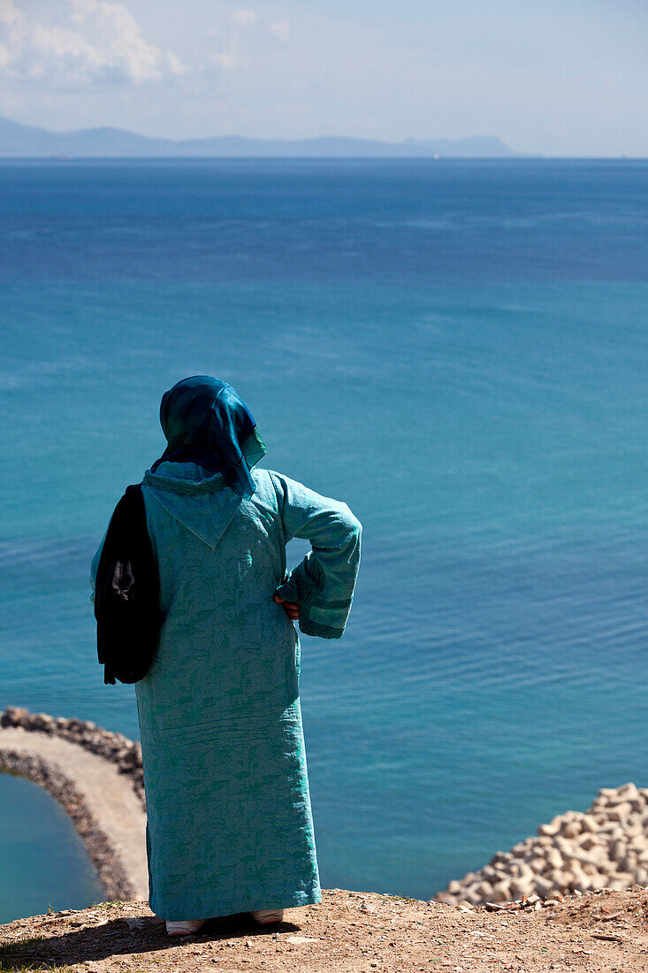 Frau schaut über die Strasse von Gibraltar, Tanger, Marokko