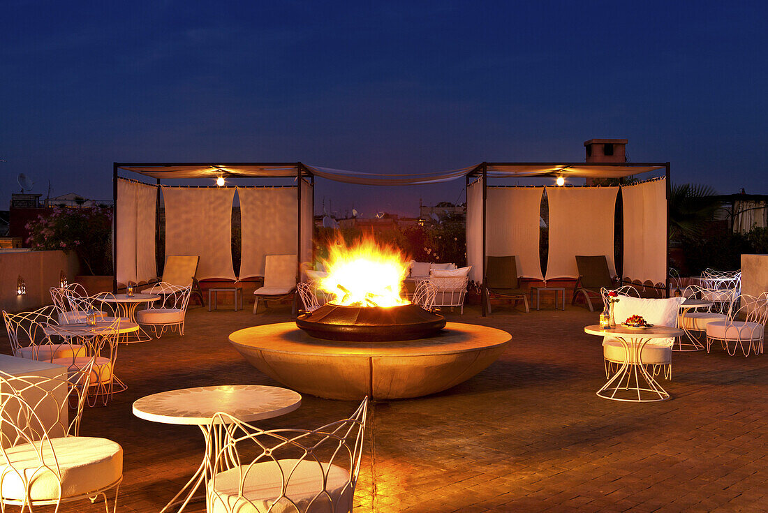 Rooftop terrace with fireplace, Riad Nashira, Marrakech, Morocco