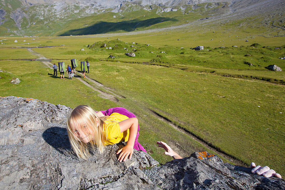 A girl bouldering, climbing, Engstligenalp, Bernese Oberland, Switzerland
