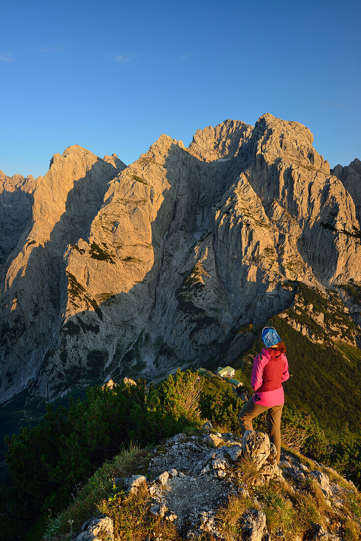 Woman looking at mountain scenery from Stripsenkopf, Zahmer Kaiser, Kaiser mountain range, Tyrol, Austria