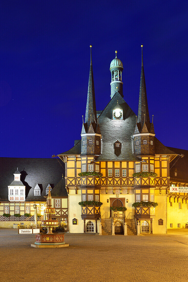 View over market square to illuminated town hall, Wernigerode, Saxony-Anhalt, Germany