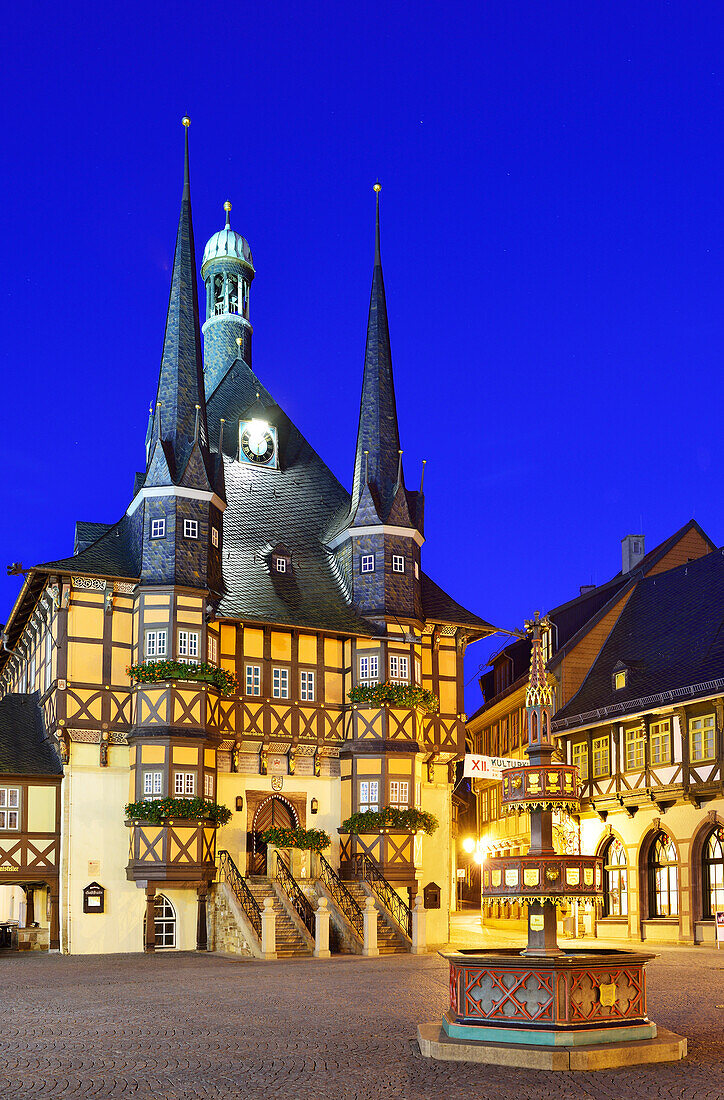 View over market square to illuminated town hall, Wernigerode, Saxony-Anhalt, Germany