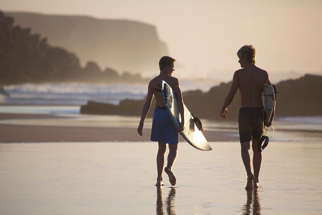 Two young surfers on Cotillo beach in Fuerteventura, Spain