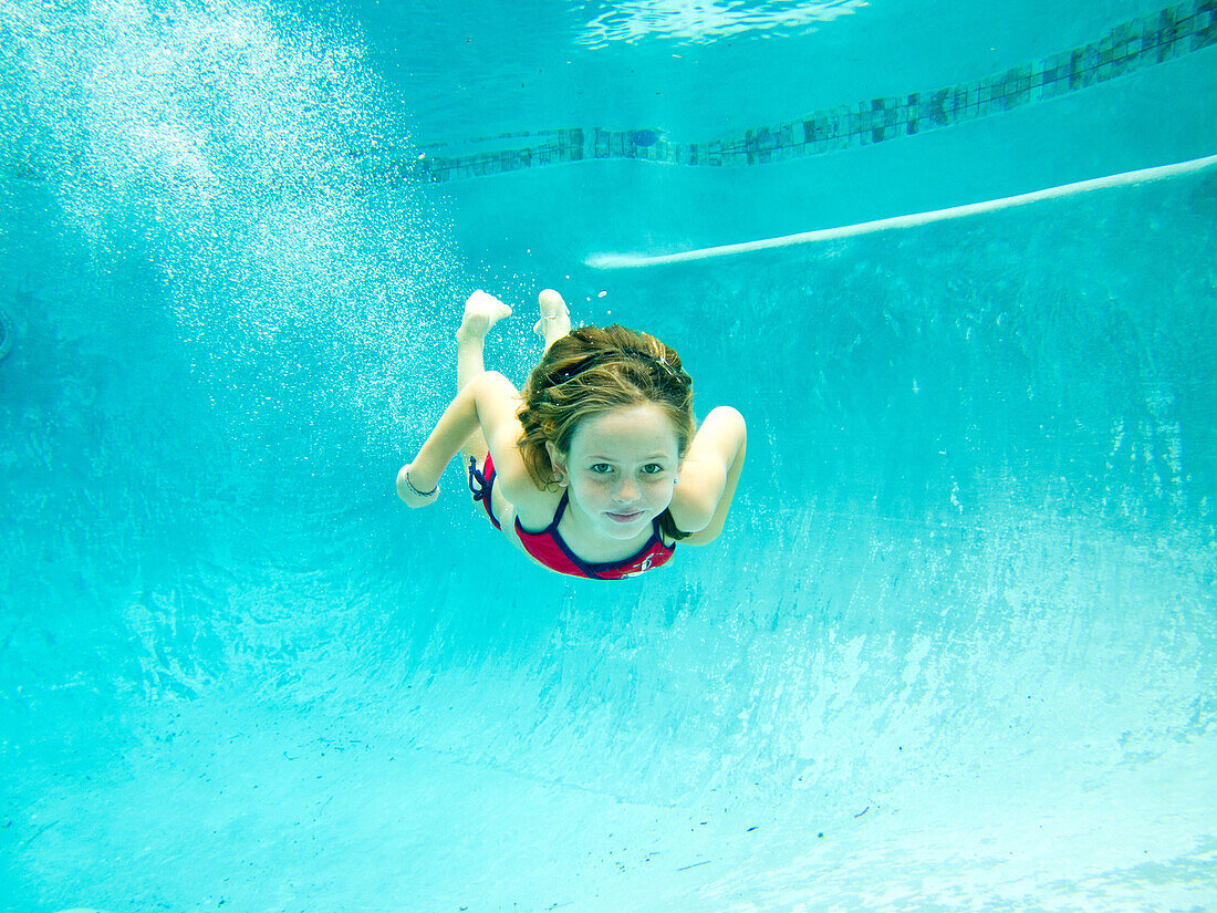 Girl Swimming Underwater in Pool, Eye Contact