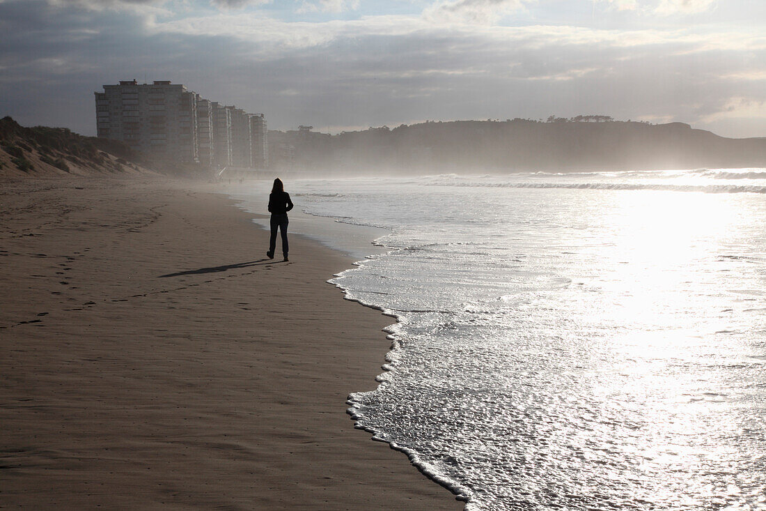Girl Walking Along Seashore, Spain