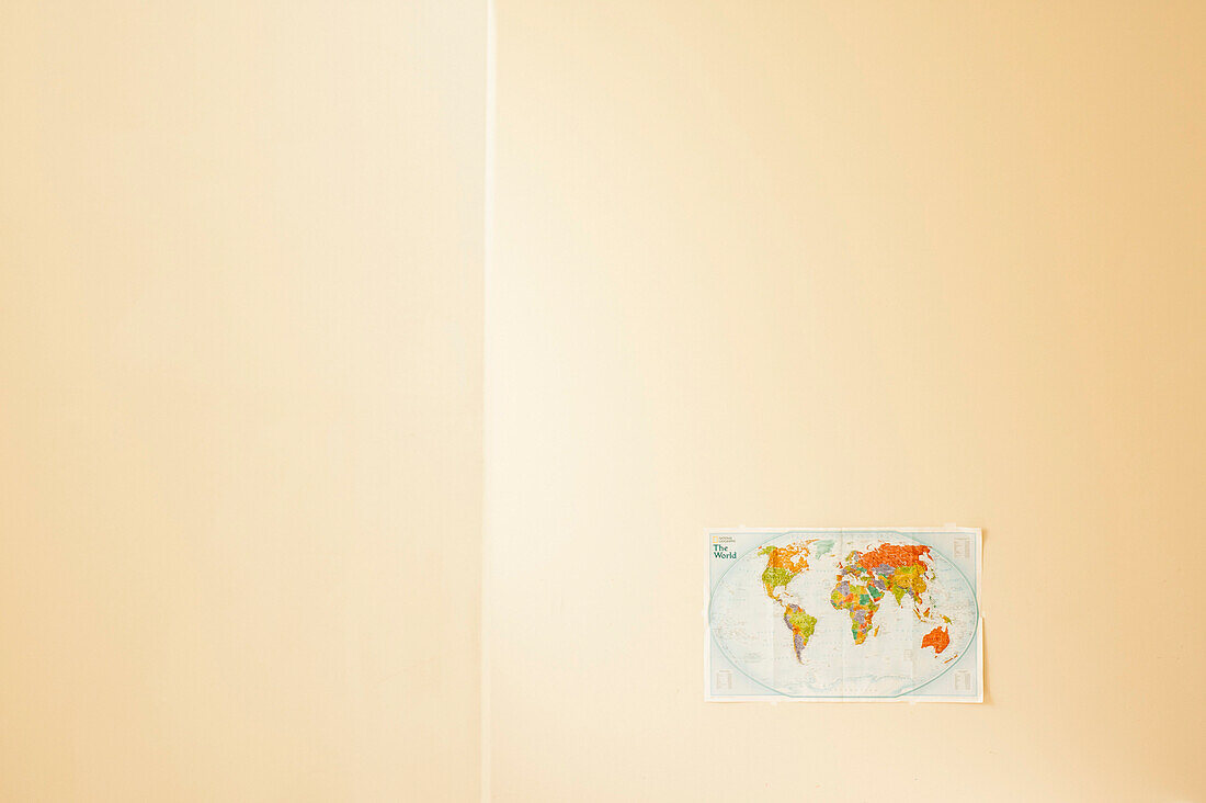 World Map Pinned to Bare Wall