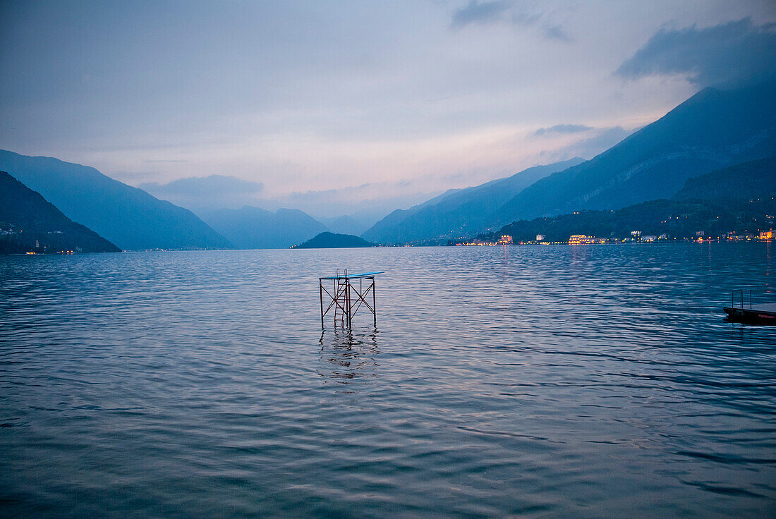 Diving Board and Platform in Middle of Lake at Sunset, Italy