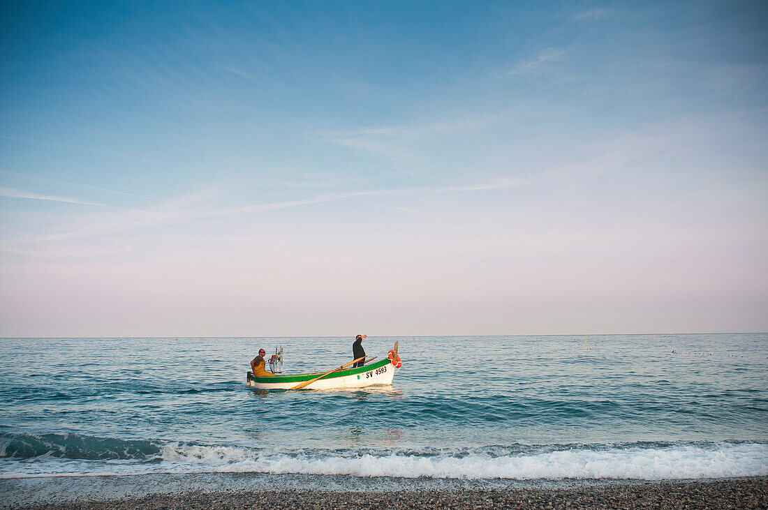Two Men in Fishing Boat at Seashore