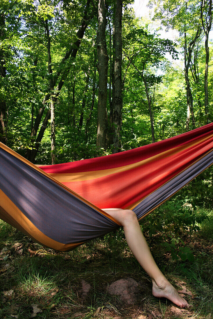 Woman With Legs Hanging out of Hammock