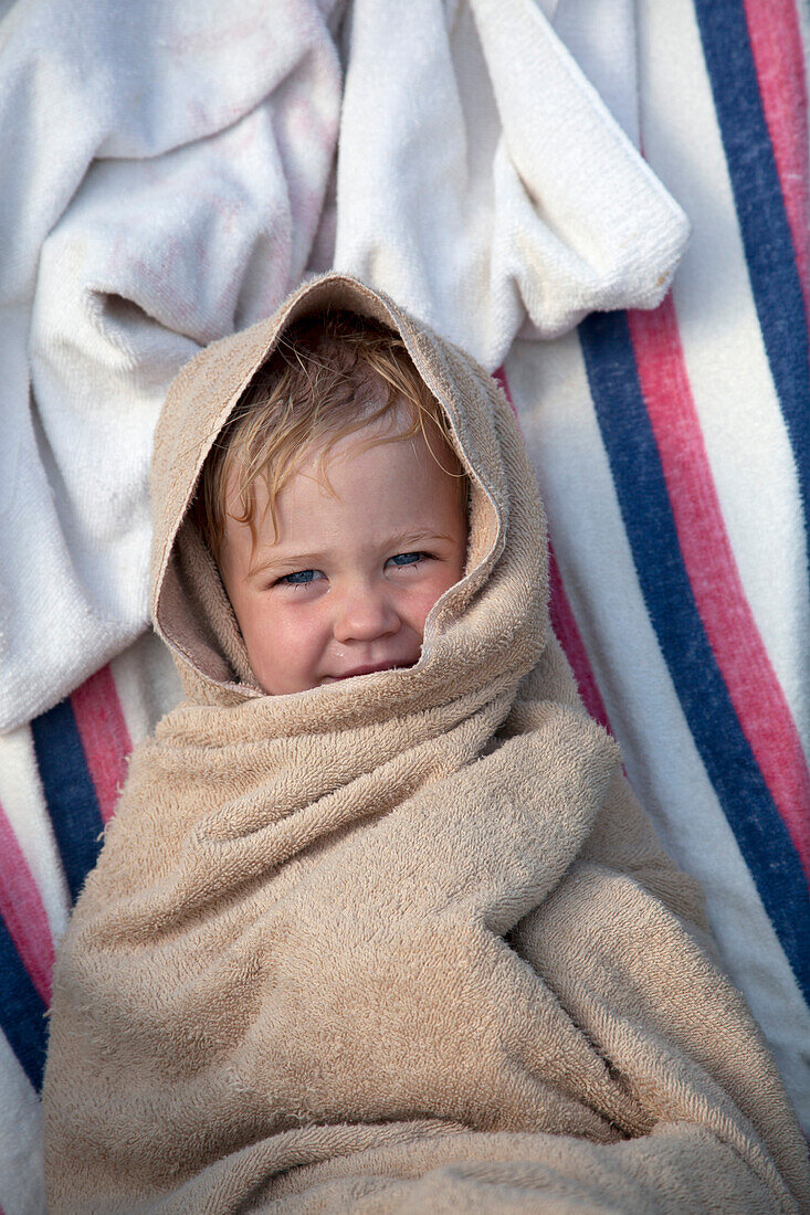 Young Boy Wrapped in Towel at Beach