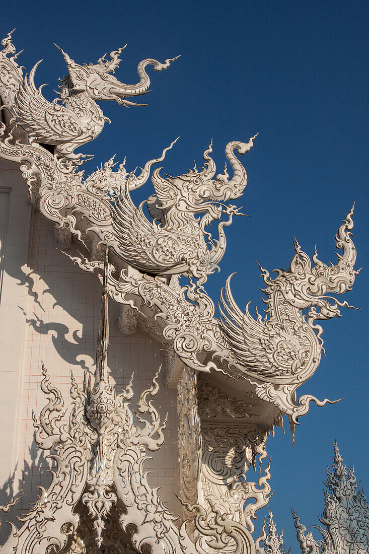 Dragons Adorning The Roof Of The White Temple Or Wat Rong Khun, Temple Built By The Thai Painter Chalermchai Kositpipat Who Wanted To Create A Lasting Tribute To Rama 1X, Region Of Chiang Rai, Thailand, Asia