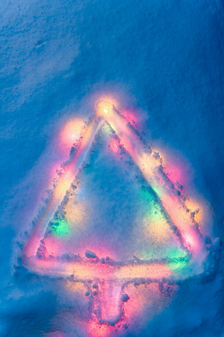 Abstract Christmas Tree Drawn In Fresh Blanket Of Snow With Christmas Lights Buried Underneath With Blue Toned Color Winter Alaska