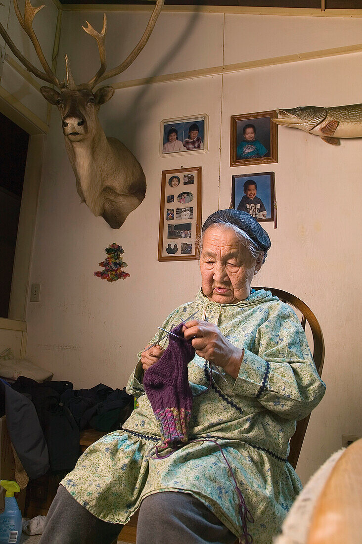 Portrait Of Female Native Yupik Elder Sitting In Living Room Knitting Akiachak We Alaska Indoors