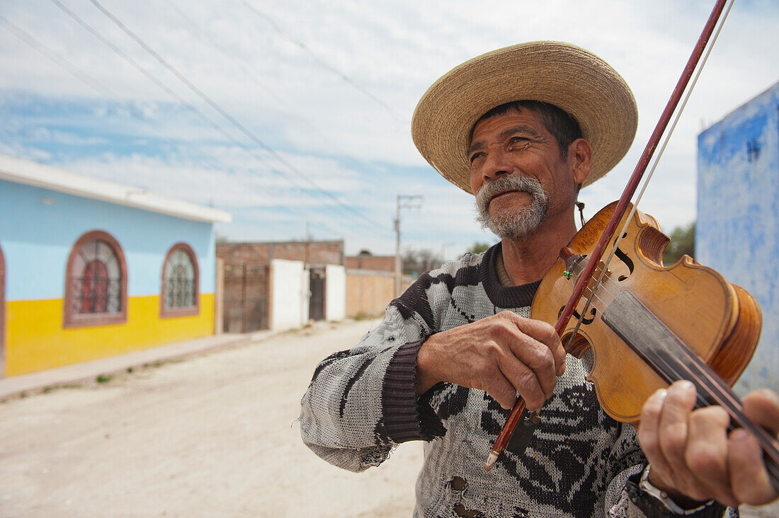 'Mexico, Man Playing Violin On Small Town Dirt Road; Guanajuato'