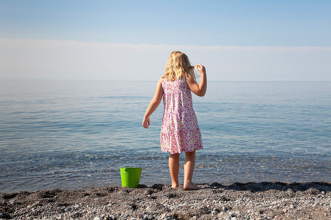 'Young Girl Playing On The Beach By Lake Ontario;Ontario Canada'