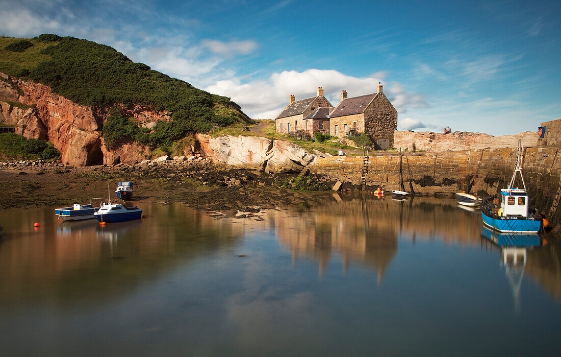 'Uk, Scotland, Scottish Borders, Fishing Boats In Harbour With Houses On Shore; Cove'