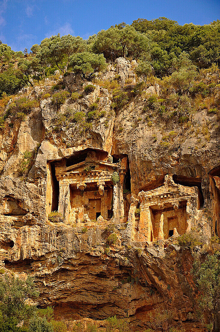The Hellenistic temple fronted Tombs of Kaunos, 4th - 2nd cent  B C, just outside the archaeological site of Kounos on the oposite side of the Calbys river from Dalyan, Turkey  Kaunos is on the border of Lycia & Caria and the Kaunos rock tombs differ sli
