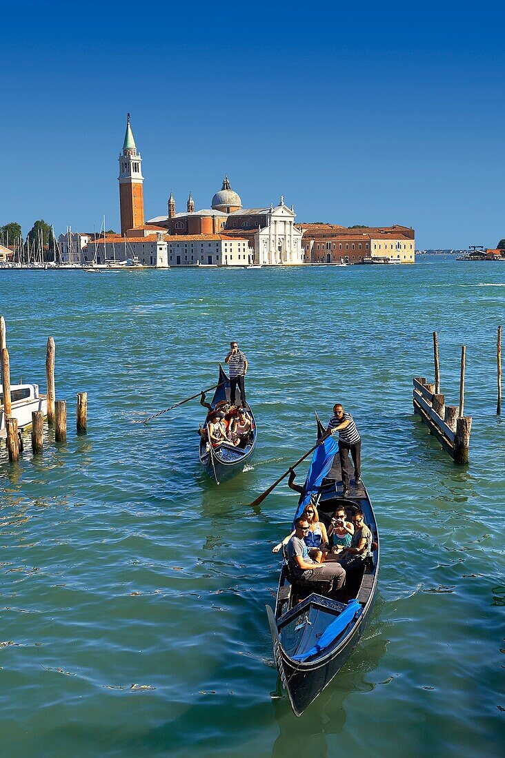 Gondolas at St Mark´s Square with the island of San Giorgio Maggiore behind, with its church front designed by Andrea Palladio and begun in 1566  Venice Italy