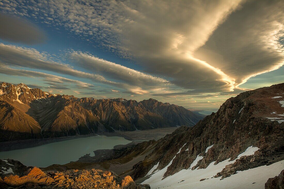 Wind clouds at dusk over Tasman Glacier Valley, from summit Mt Kinsey, Aoraki Mount Cook National Park, Canterbury New Zealand