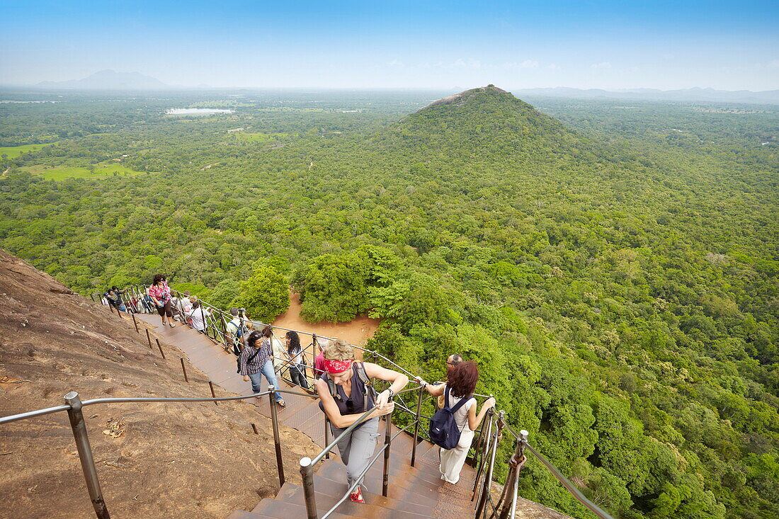 Sri Lanka - Sigiriya, tourists on stairs of Lion´s Gate to the ancient fortress, ancient Royal Fortress in Sri Lanka, UNESCO World Heritage Site