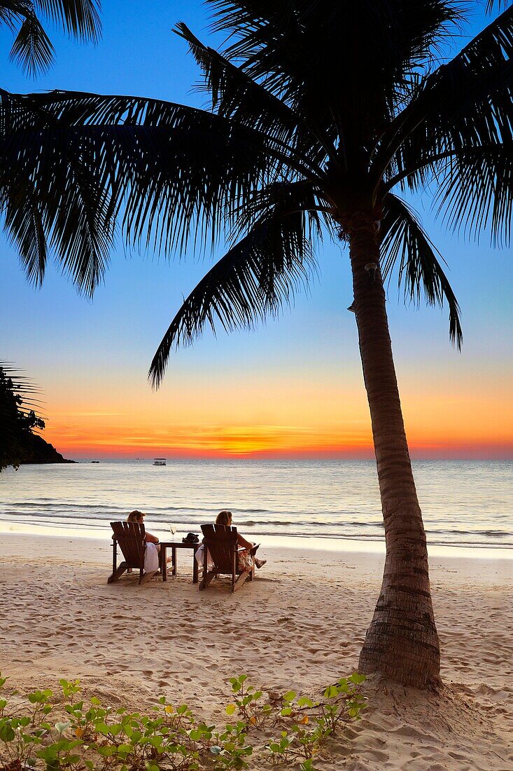 Tourists resting, Thailand Beach after sunset, Koh Samet Island, Thailand