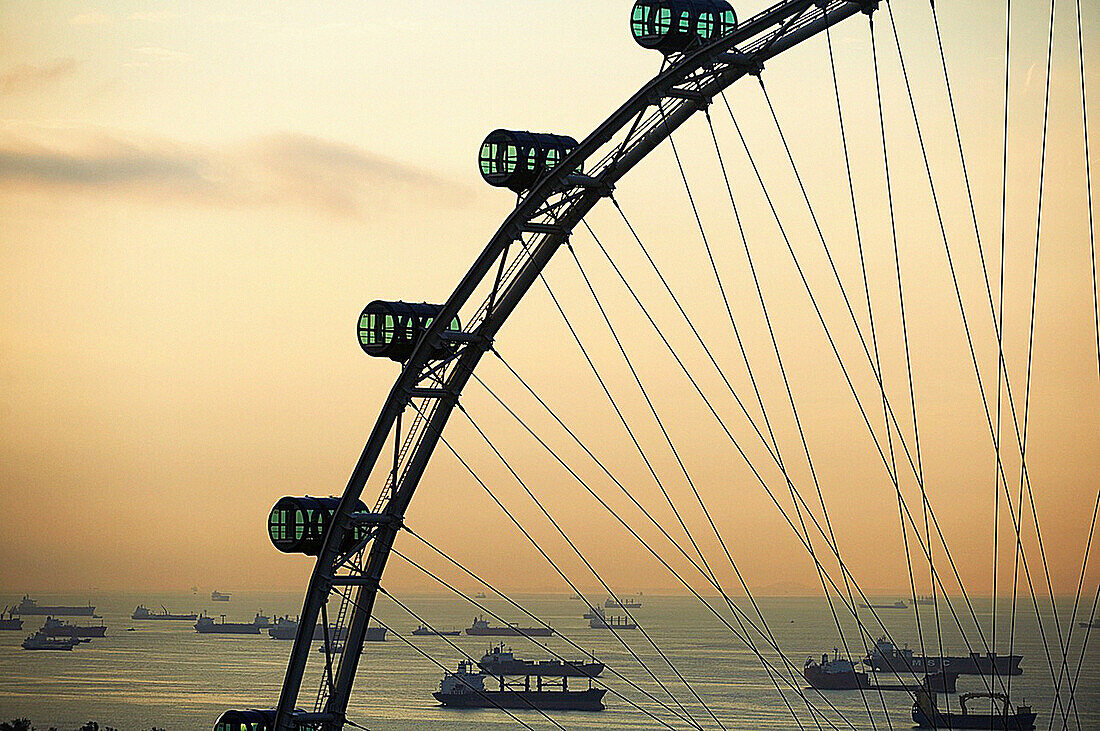 Shipping boats and freighters at sunset off the coast of Singapore as seen through the Singapore Flyer