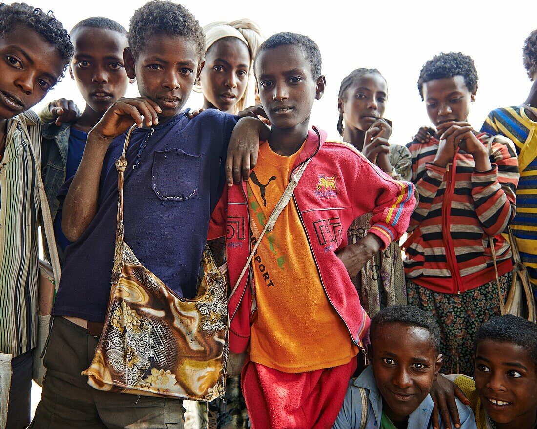 A group of local children making faces and posing for the camera