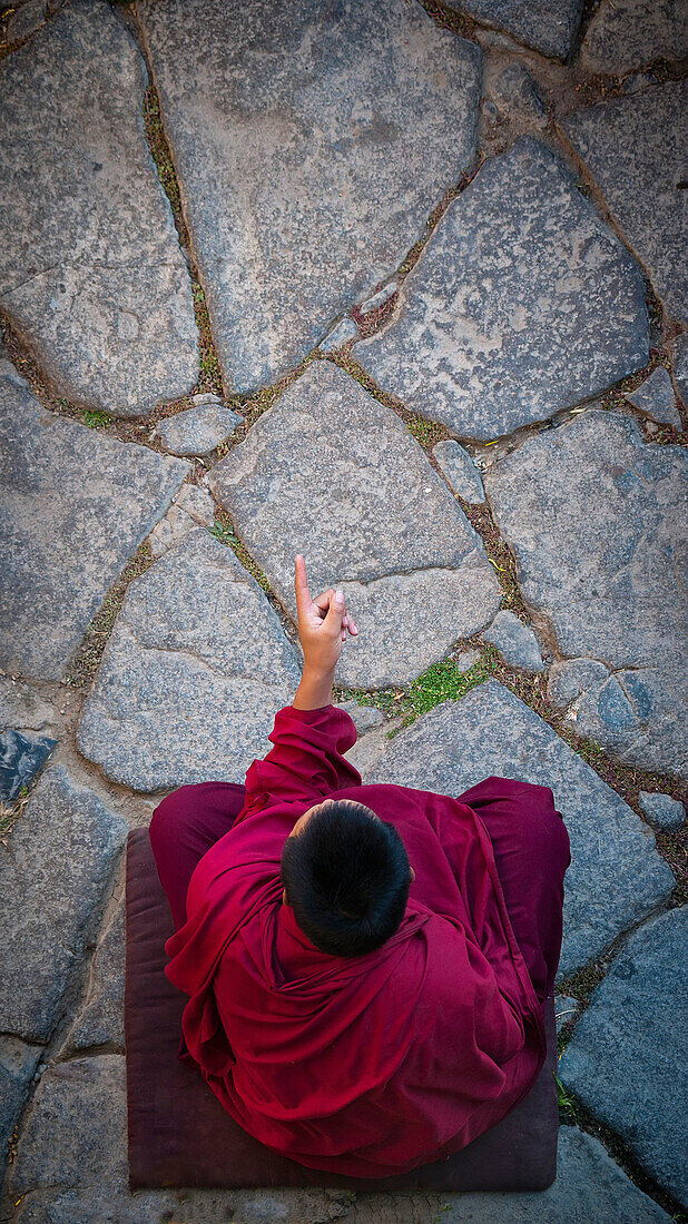 Alex, Adams, Outdoors, Day, Elevated View, Full Length, Gesturing, Sitting, Black Hair, Short Hair, Men, One Person, Traditional Culture, Religion, Buddhism, Pattern, Traditional Clothing, Individuality, Mystery, Spirituality, Pointing, Tibet, Monk-Religi