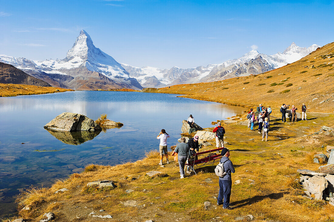 Tourists by Stellisee Lake and Matterhorn, Valais, Switzerland