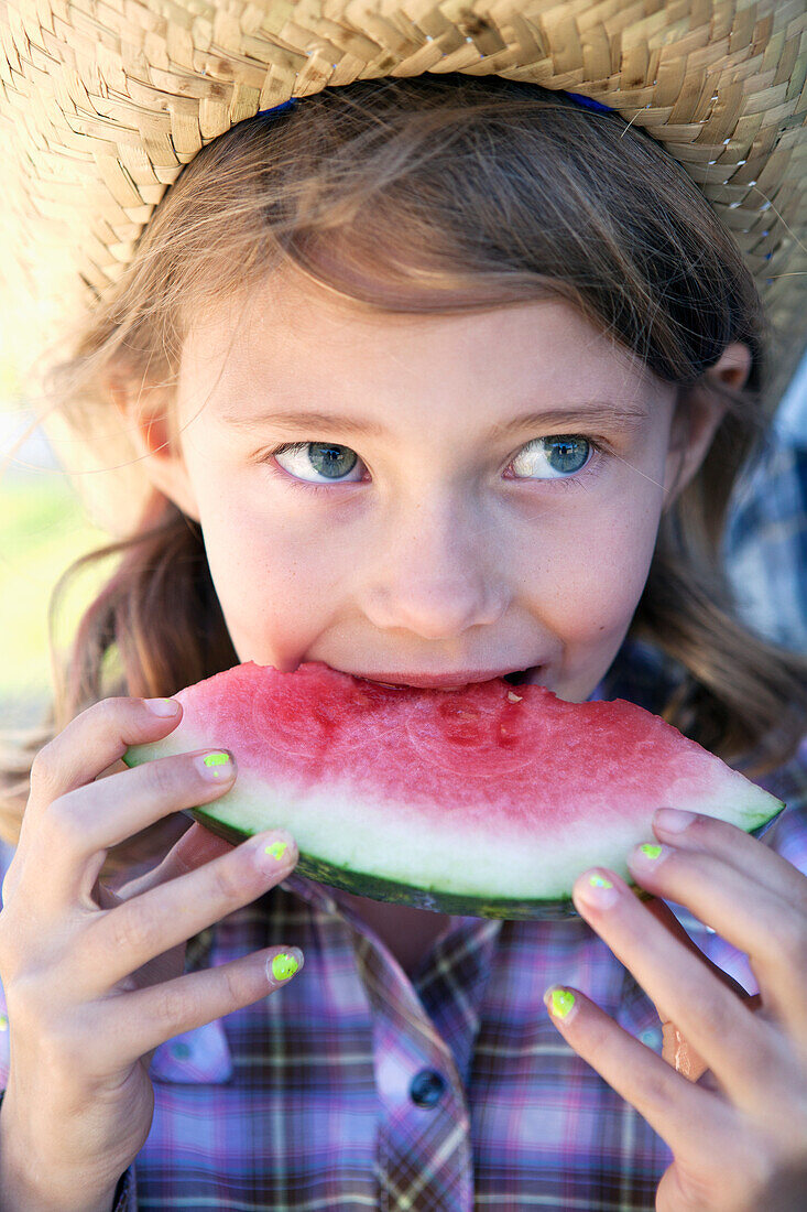 Young girl eating a slice of watermelon, Langley british columbia canada