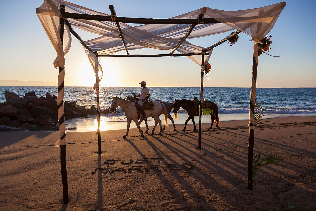 Horse vendor ends his day at beach where destination wedding was held, Puerto Vallarta, Mexico