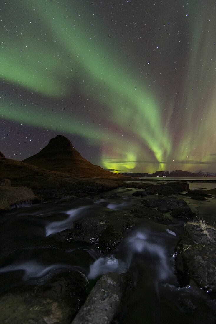 Northern lights (aurora borealis) over kirkjufell in the town of Grundarfjorthur, Snaefellsness Peninsula, Grundarfjorthur, Iceland
