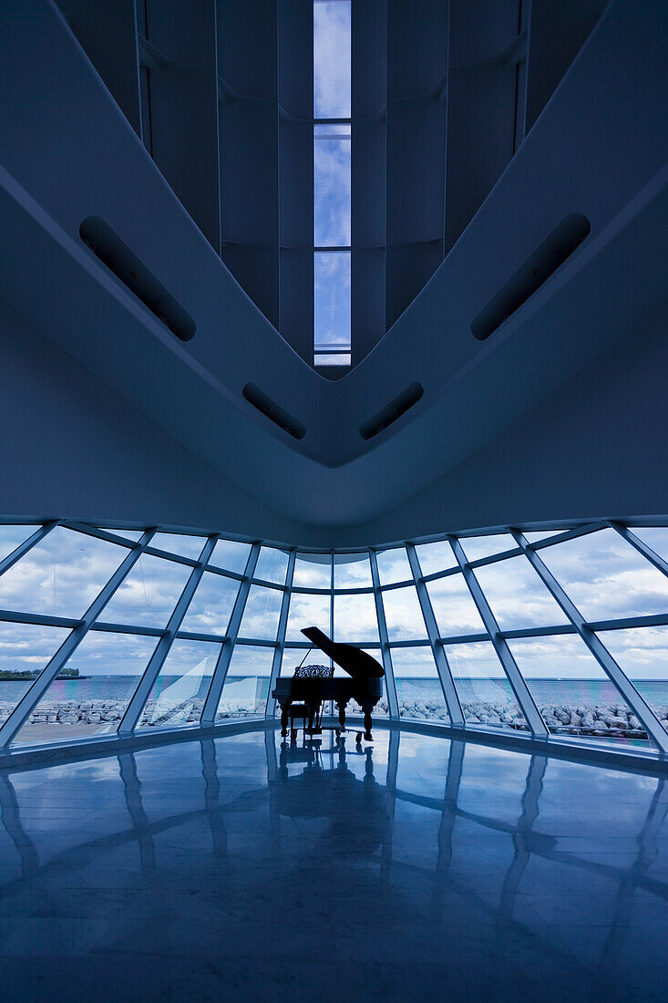A grand piano in the corner of a room of glass walls overlooking the water, Milwaukee, Wisconsin, United States of America