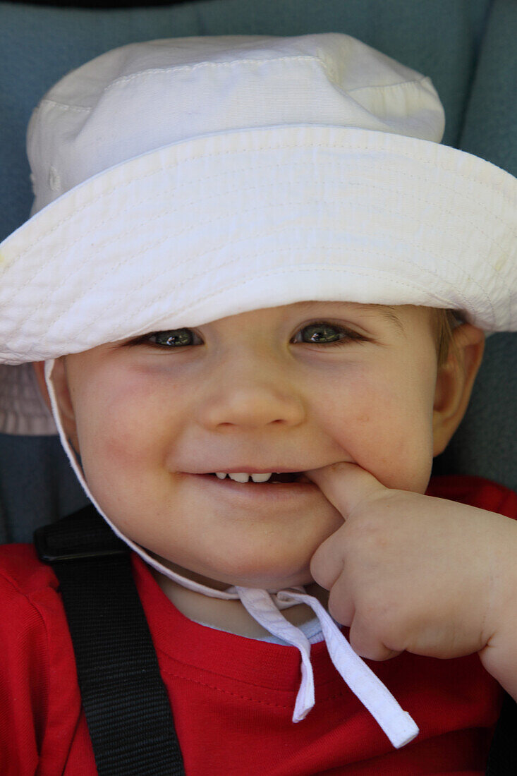 Smiling Baby with One Finger in Mouth