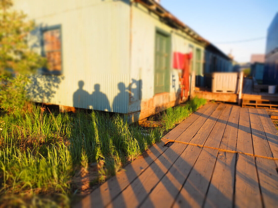 Group of Human Shadows on  Building Wall, Midnight Sunlight, Alaska, USA