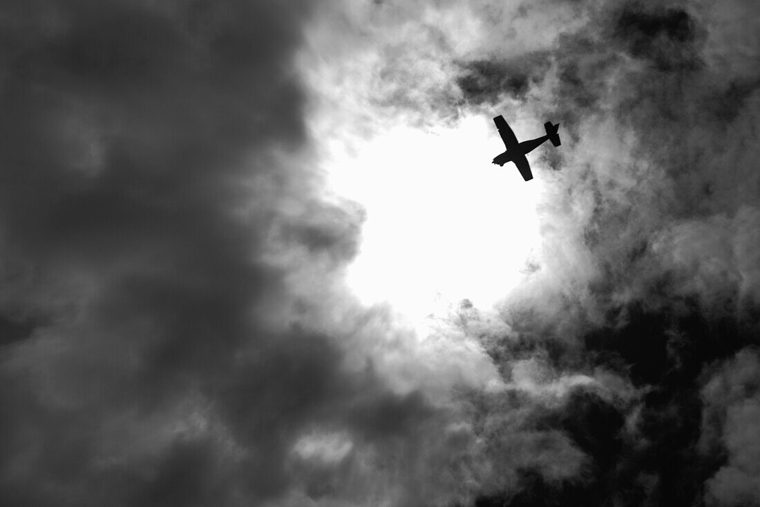 Airplane Silhouette Against Dramatic Sky, Low Angle View