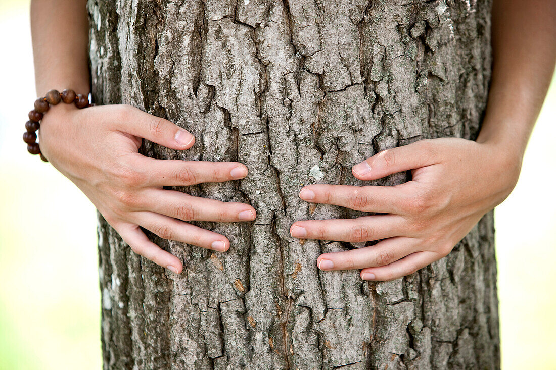 Woman hugging a tree, Styria, Austria