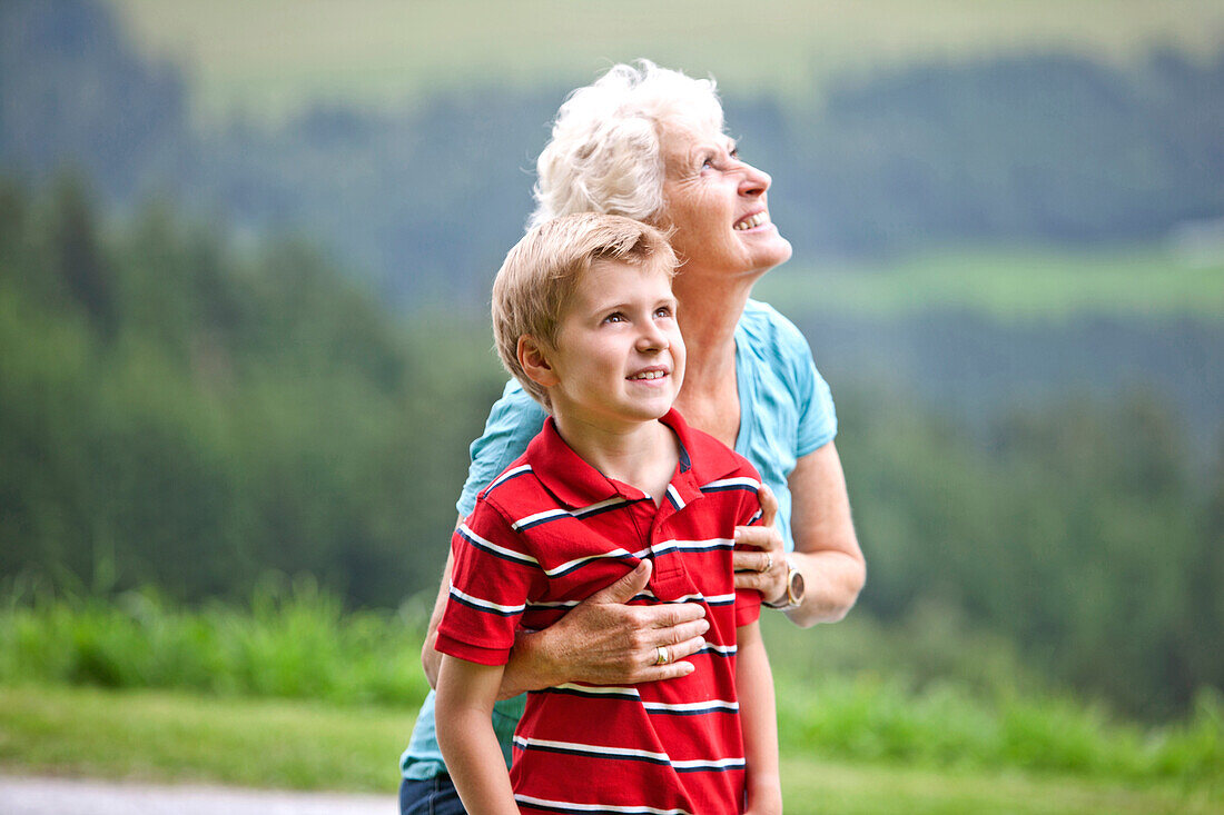 Grandmother and grandson (7 years) looking up, Styria, Austria